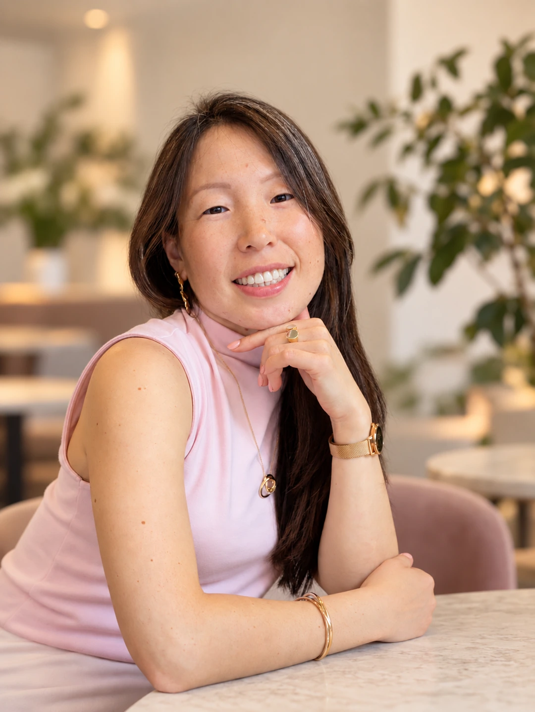 Dashima Dambieva smiling, seated in a softly lit setting